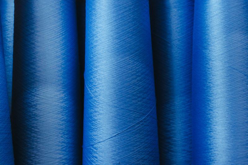 Blue yarn packages in a row